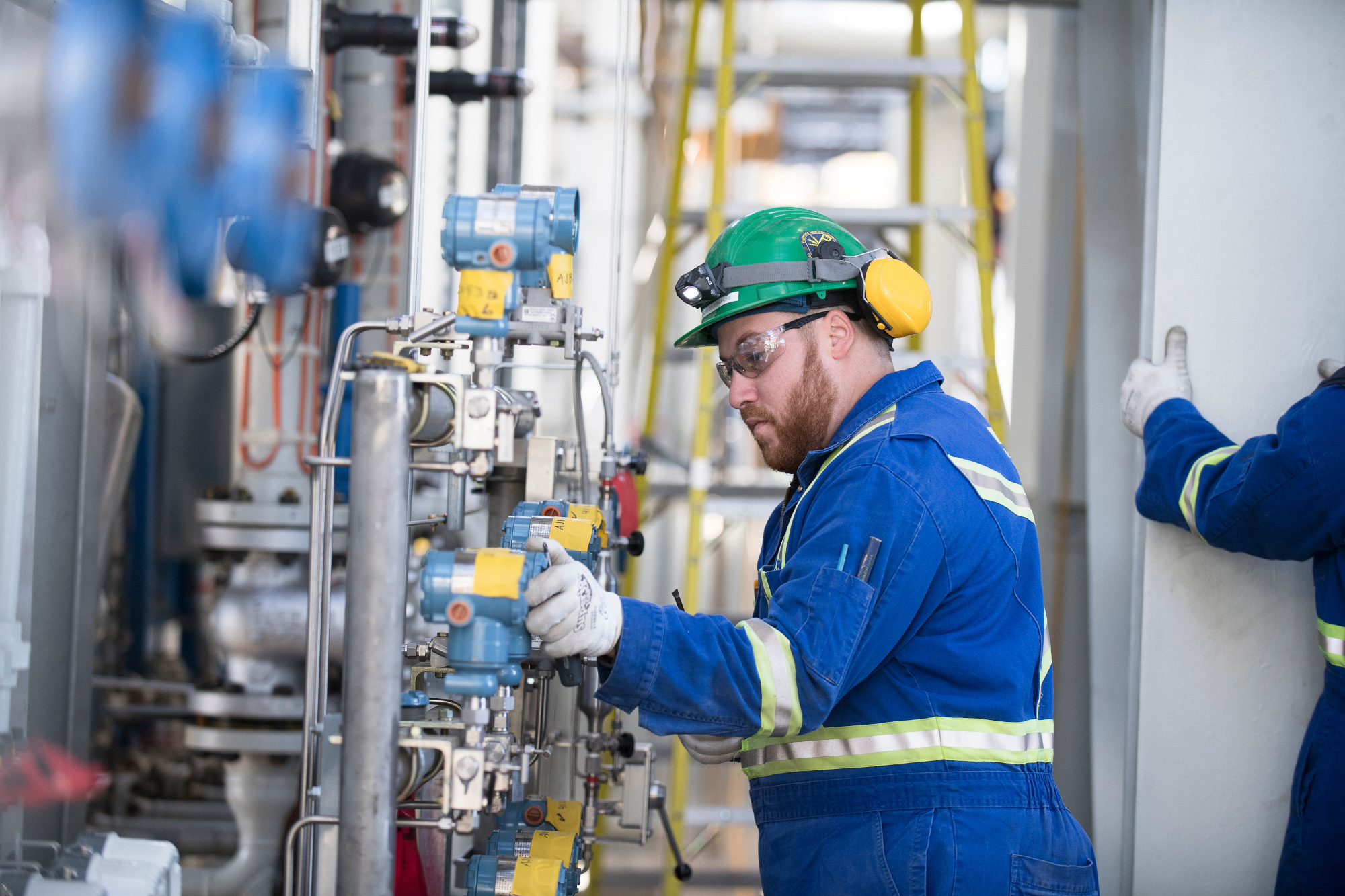 B&M engineer inspecting a mechanical system in a plant