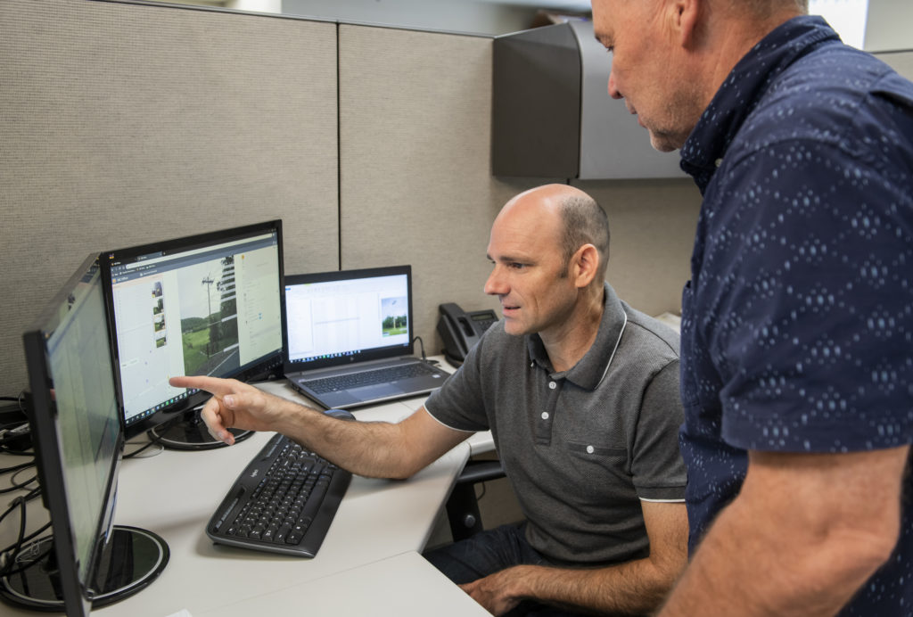 Two B&M experienced professionals discussing about a project on a computer