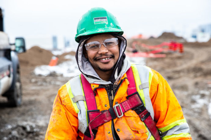 B&M's skilled trade professional working at a construction site posing for a photo