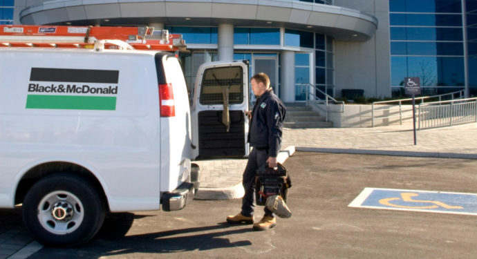 B&M service technician opening the door of a service van to load his equipment.