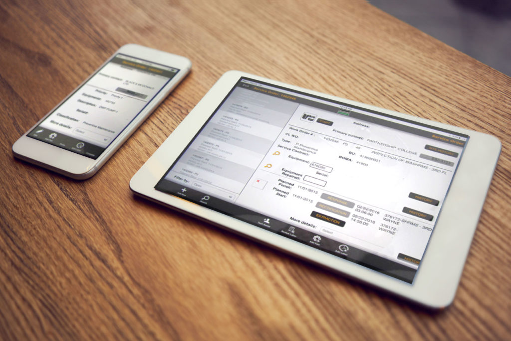 A service technician's hand-held device and tablet showing a dashboard of work orders in progress.