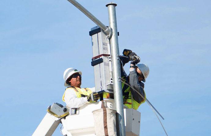 Two B&M engineers installing a high speed fibre and small cell antennae network