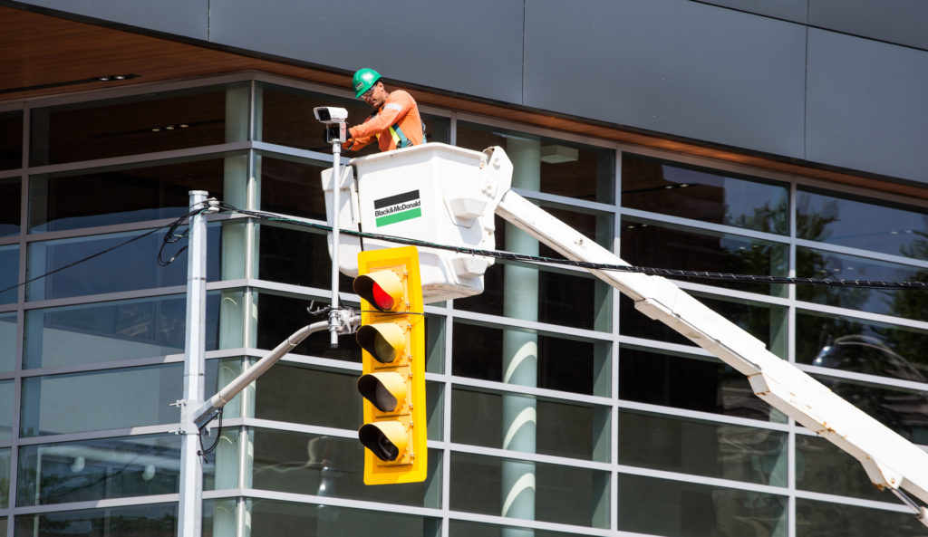 B&M's ITS tradesperson installing a traffic management system at a busy intersection