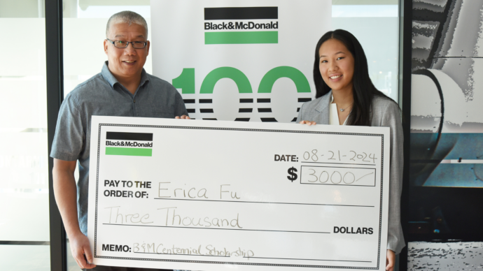 a Scholarship student, with her father receiving a novelty cheque