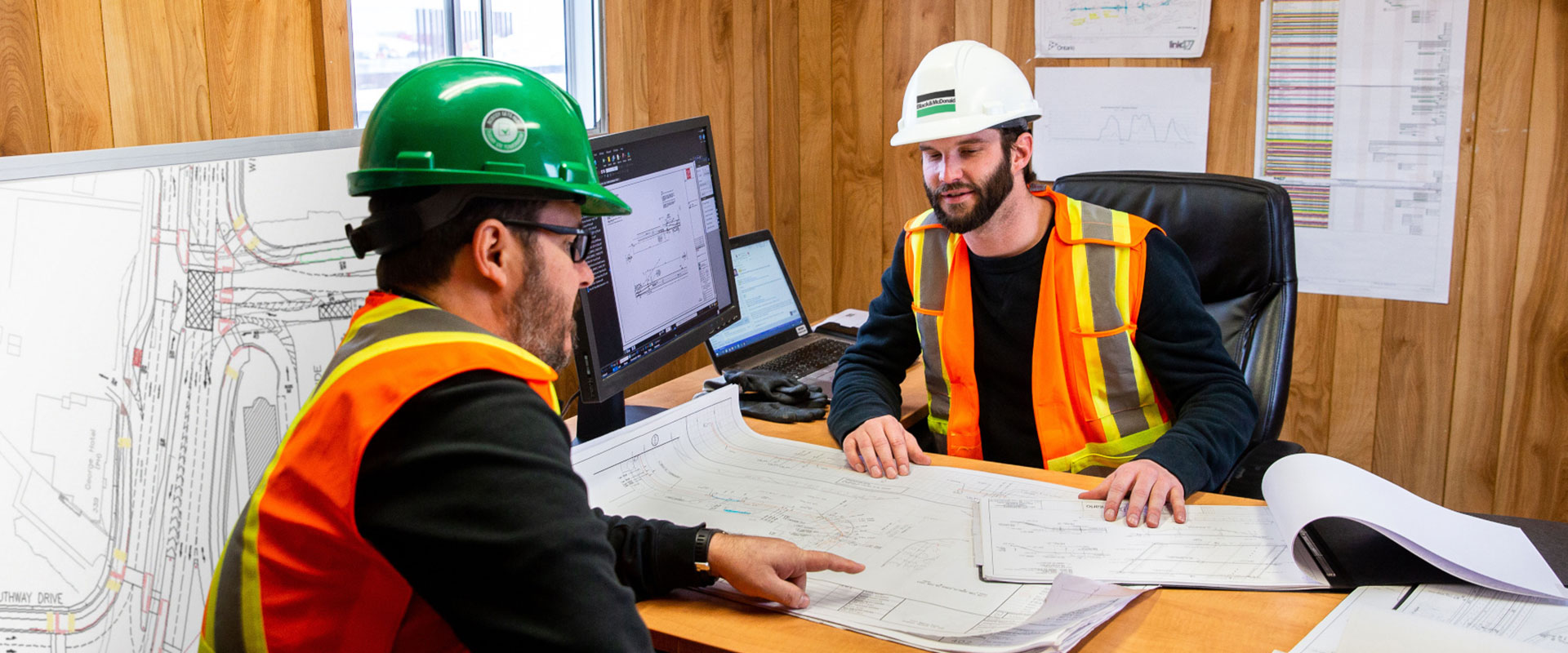Two B&M employees discussing a construction project in an office environment