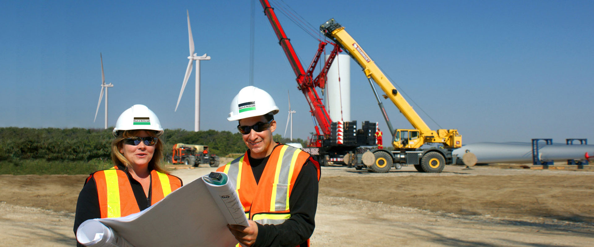 B&M construction project team discussing a wind farm project in the field